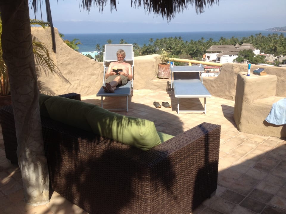 Rooftop with couch, chaise lounges and shade palapa.  Relax with a cold drink...