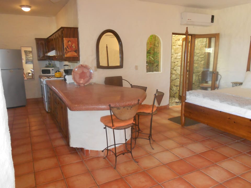Upper level 2 kitchen, door leads to bath, ocean view throughout, artisan detail