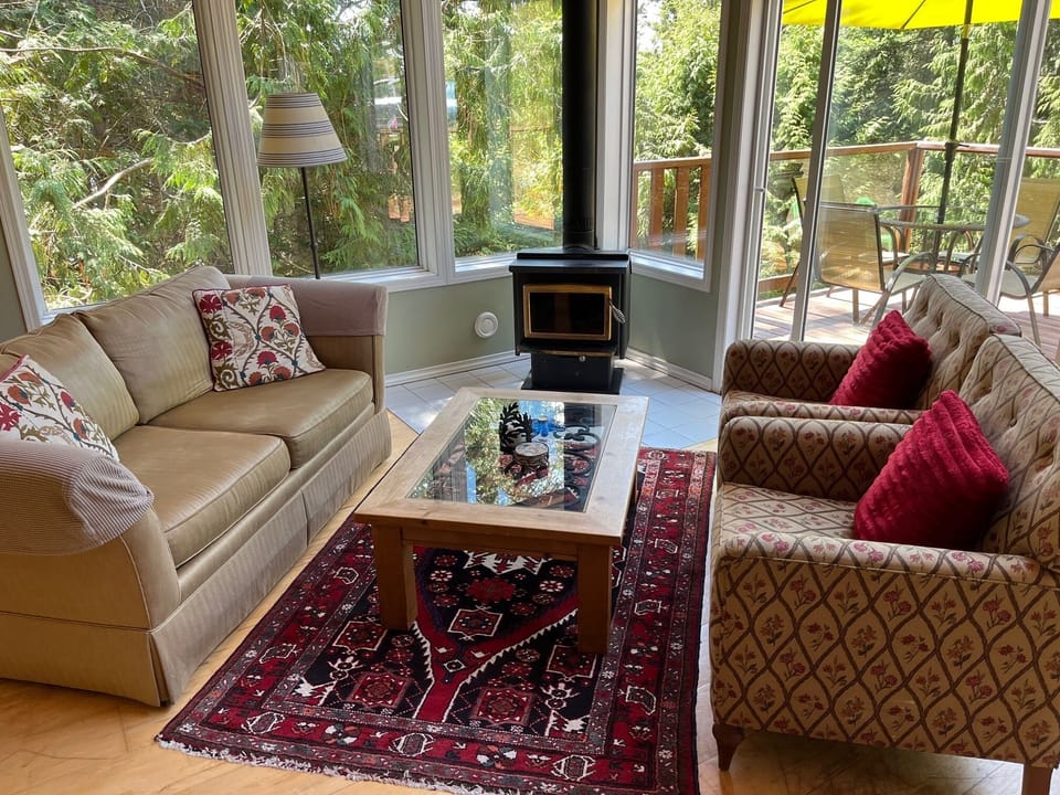 bright living room with wood burning fireplace