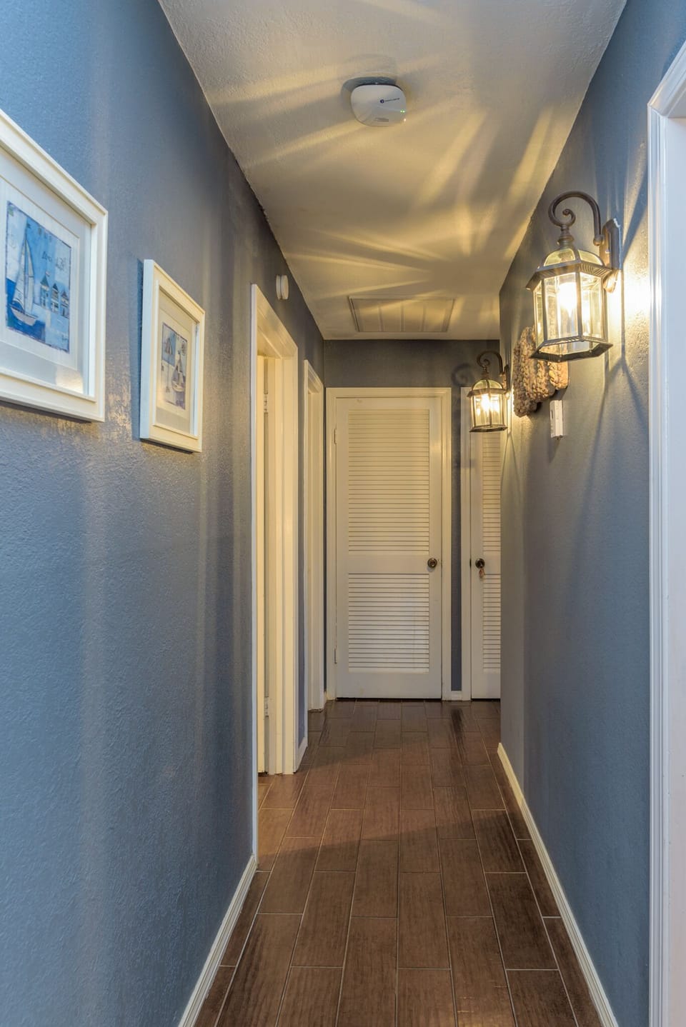 hallway leading to bedrooms & bathrooms