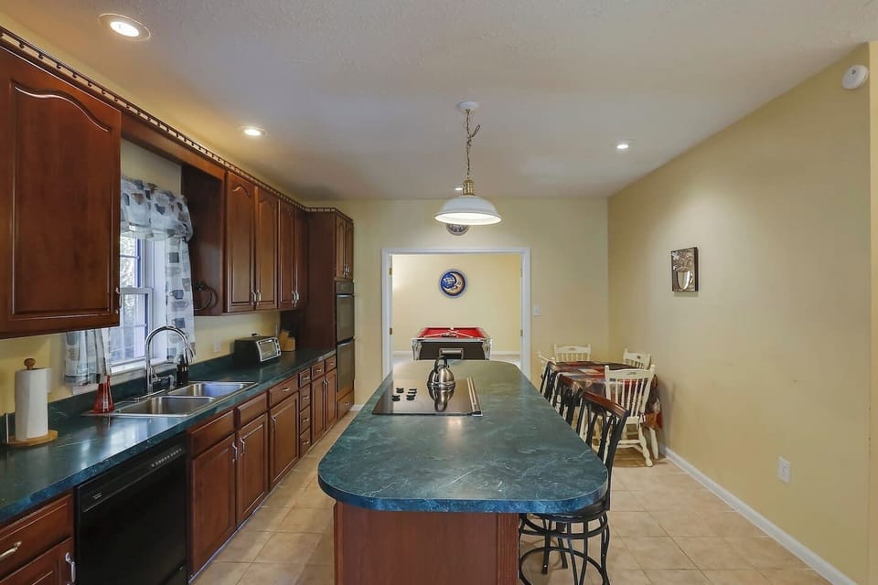 Kitchen seats up to 13 people (w/ table leaf and extra chairs).
