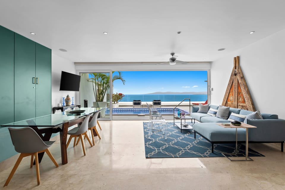 Antique filled upper level living room open to terrace with panoramic ocean view