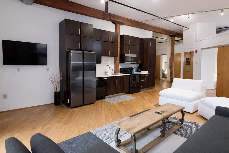 Spacious kitchen and living room area with queen sleeper sofa.