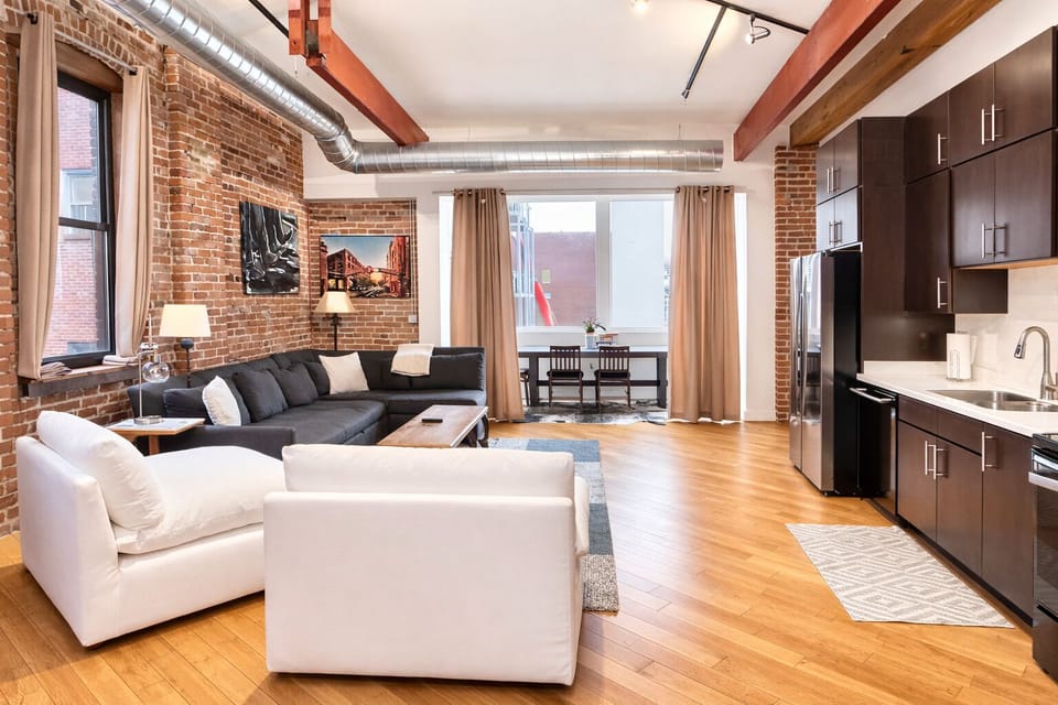 Spacious kitchen and living room area with queen sleeper sofa.