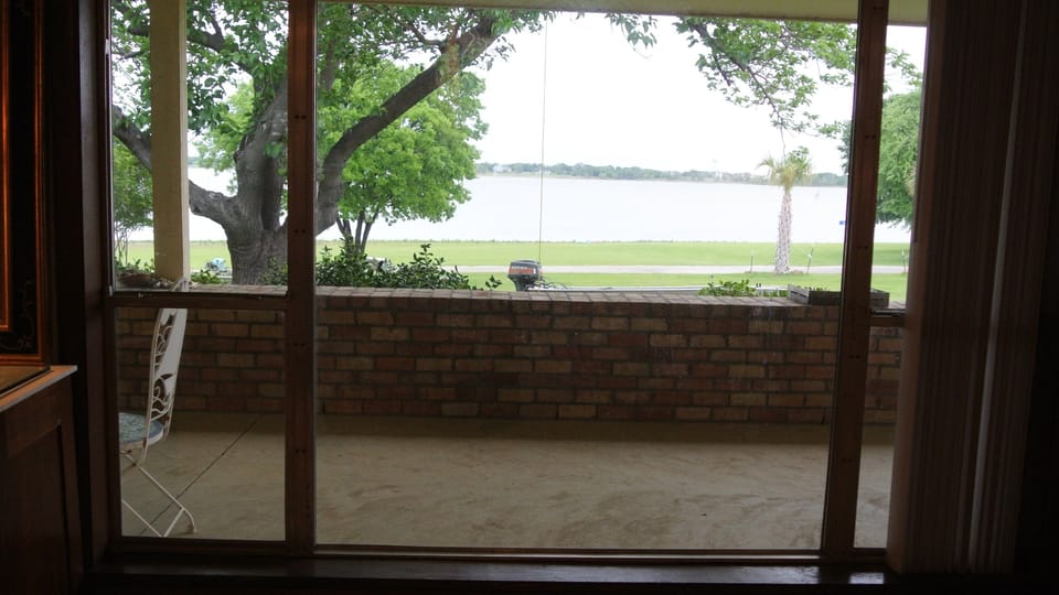 Second bedroom view of the water, and palm trees swaying in the breeze. 