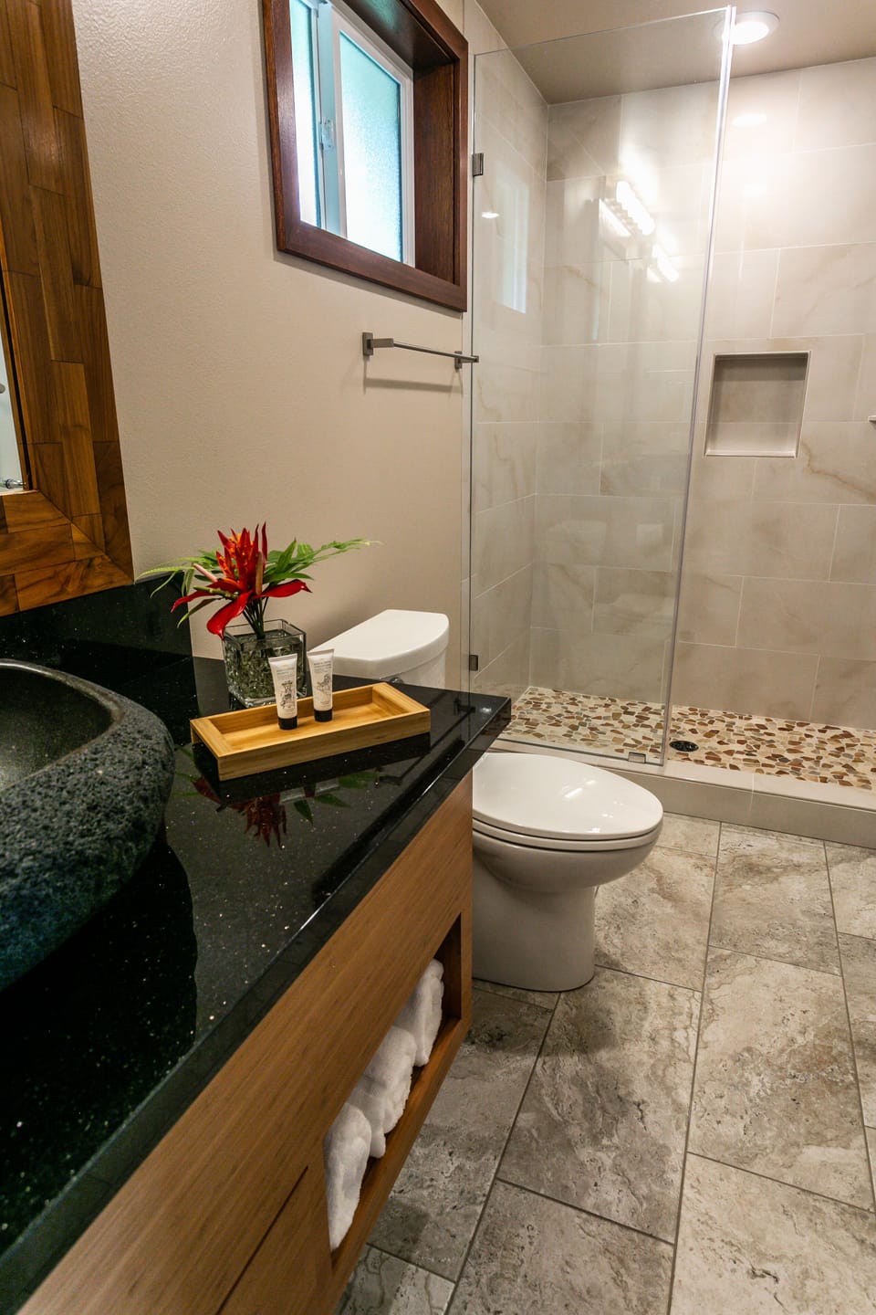 Contemporary Glass Shower with Stone Pebbles.
