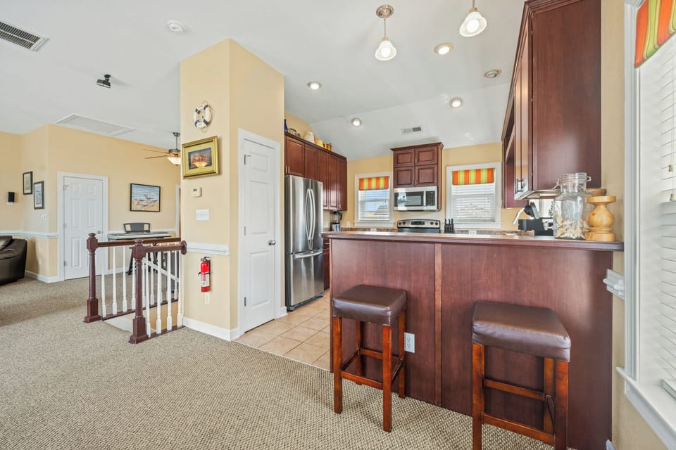 Kitchen with Bar Seating on Third Level