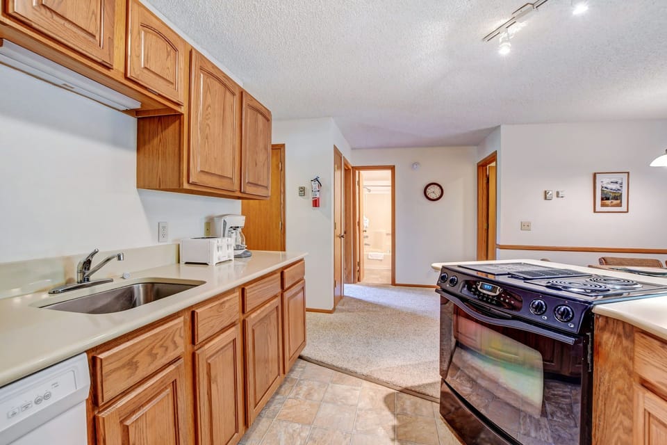 View of full kitchen to hallway bathroom