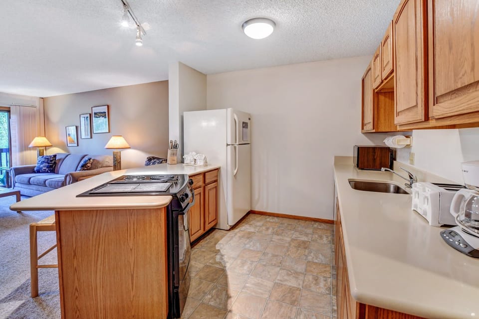 View of full kitchen and counter seating