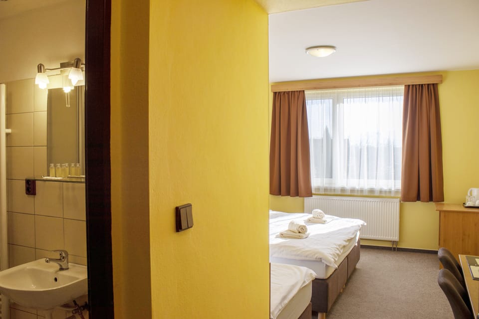 Triple Room | Desk, blackout drapes, cribs/infant beds, rollaway beds