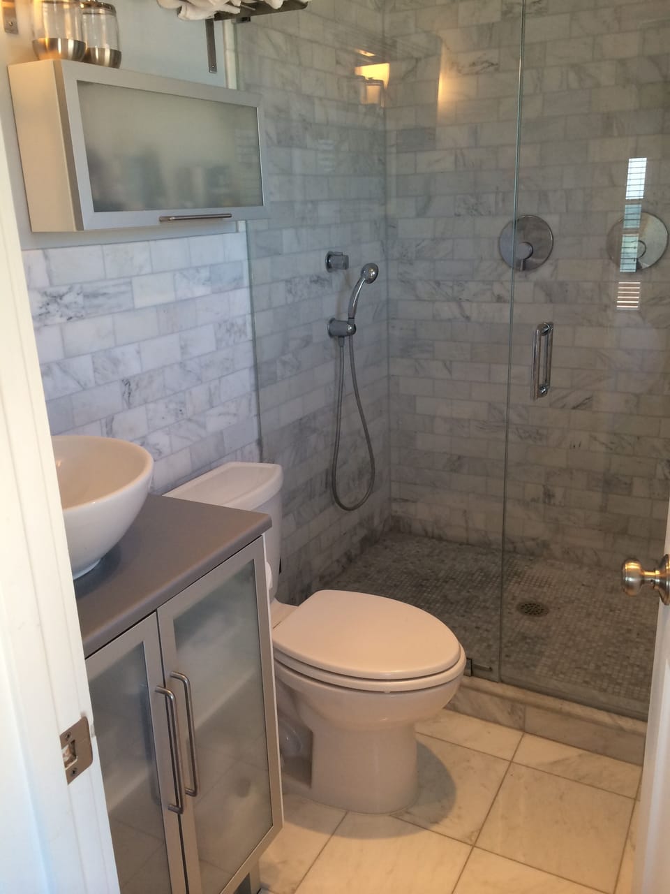 Master bath with two shower heads and white Carrara Marble