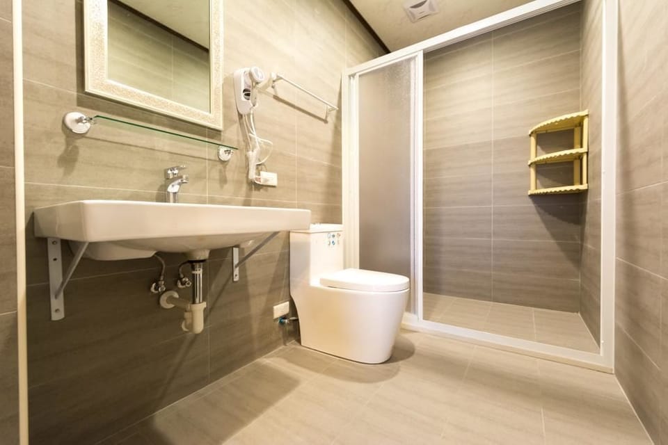 Standard Quadruple Room (301) | Bathroom | Hair dryer, slippers, towels, toilet paper