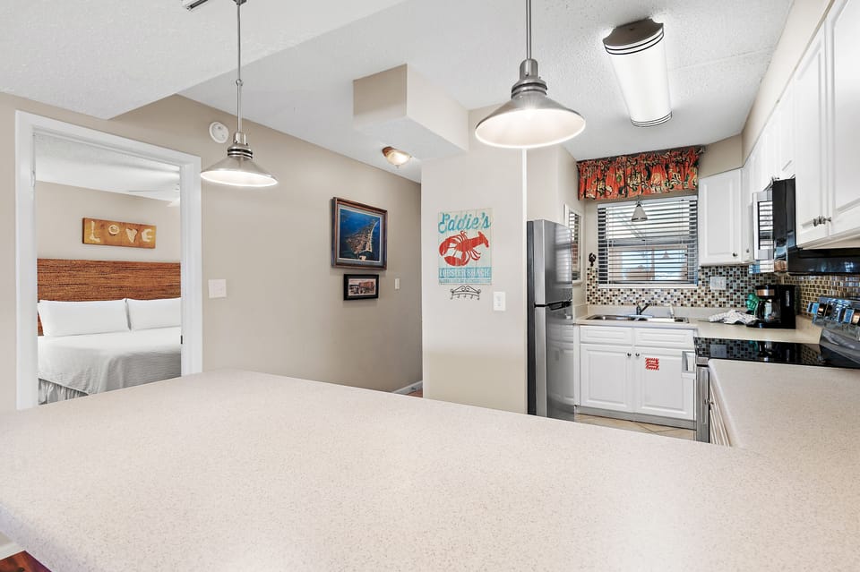 Step into your open-concept retreat, where the kitchen flows seamlessly into the living space. Enjoy your morning coffee at the spacious counter before retreating to your cozy bedroom just steps away.