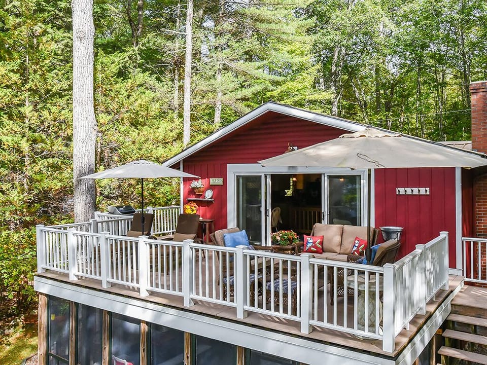 Large deck overlooking lawn and lake