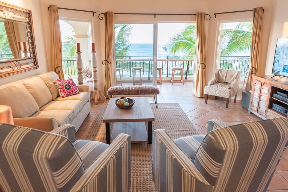 Beautifully furnished living room with sweeping ocean views. 
