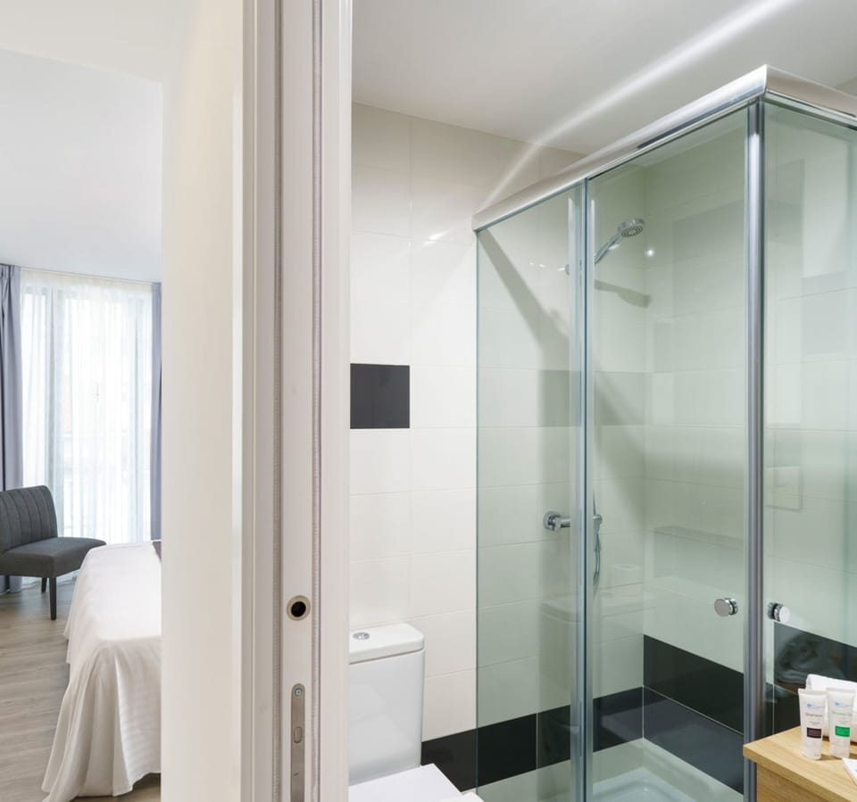 Shower, designer toiletries, hair dryer, towels