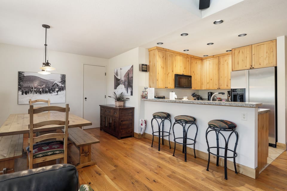 Cook your favorite meals in this fully-equipped kitchen with granite counters, stainless appliances, and cozy breakfast bar seating for three.