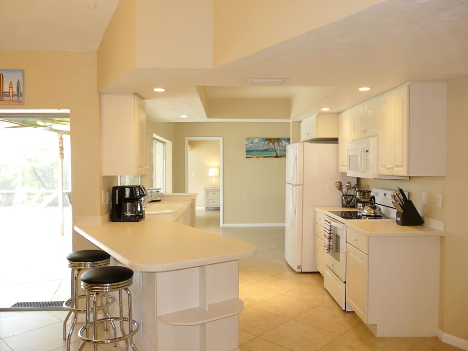 Open kitchen with decent coffee maker, knives set, pots, toaster, blender, etc.