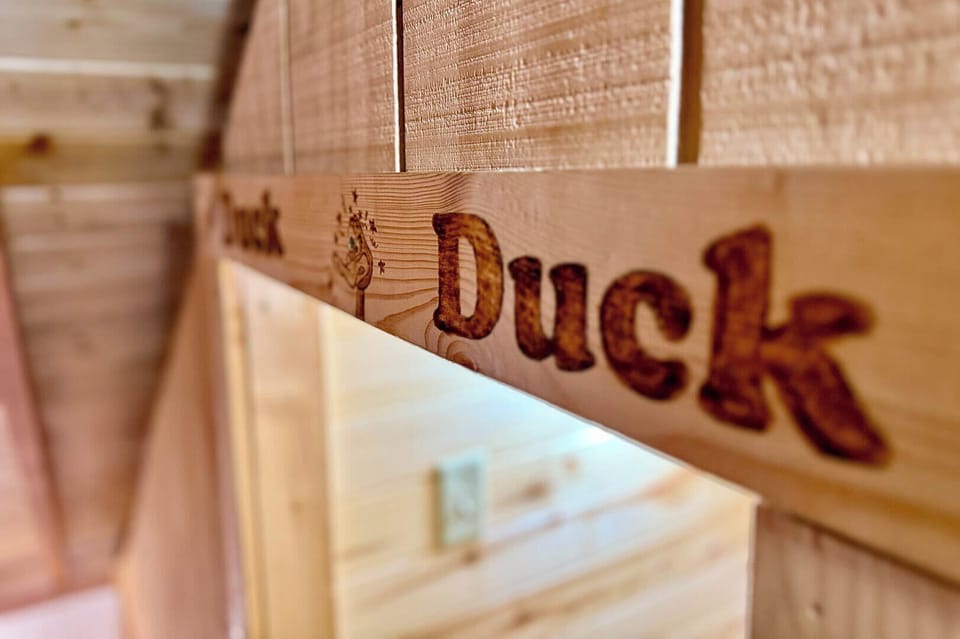 Charming details like this 'Duck' sign add a personalized, rustic touch to your HappyOur Ranch cabin getaway!