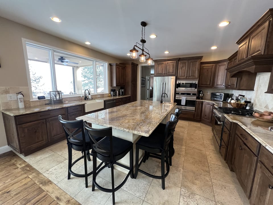 Kitchen complete with two ovens, five burners, microwave, and more