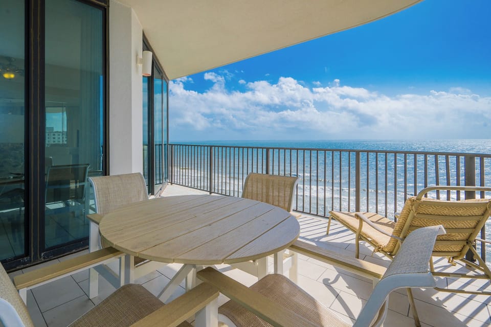 Relax on the spacious balcony with a dining table and lounge chair, enjoying the refreshing breeze and views