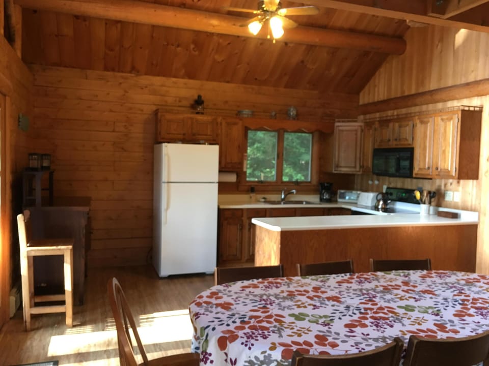 Dining room table open to the well-stocked kitchen.