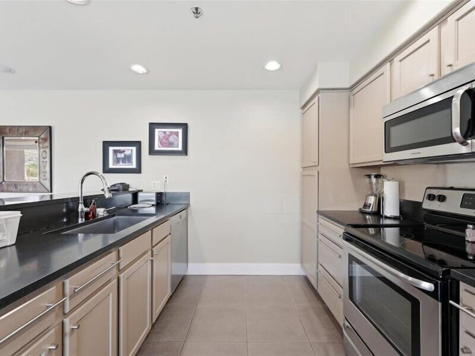 A fully equipped galley kitchen ready for all your culinary adventures, with sleek countertops, modern appliances, and everything you need to prepare your favorite meals during your stay.