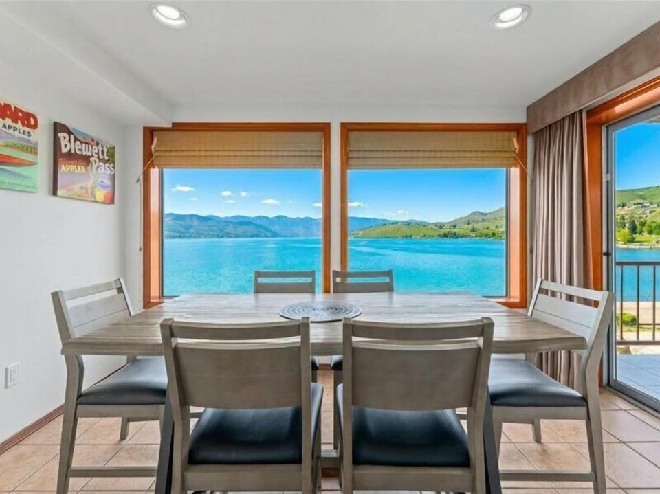 Savor meals while gazing at stunning lake and mountain views through floor-to-ceiling windows in your elegant dining space.
