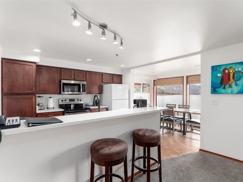 Your spacious kitchen features granite counters, stainless appliances, and a breakfast bar where you can sip morning coffee while planning your day's adventures.