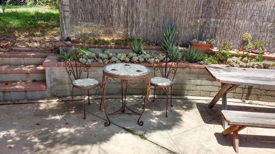 Outdoor patio table and chairs and picnic table.