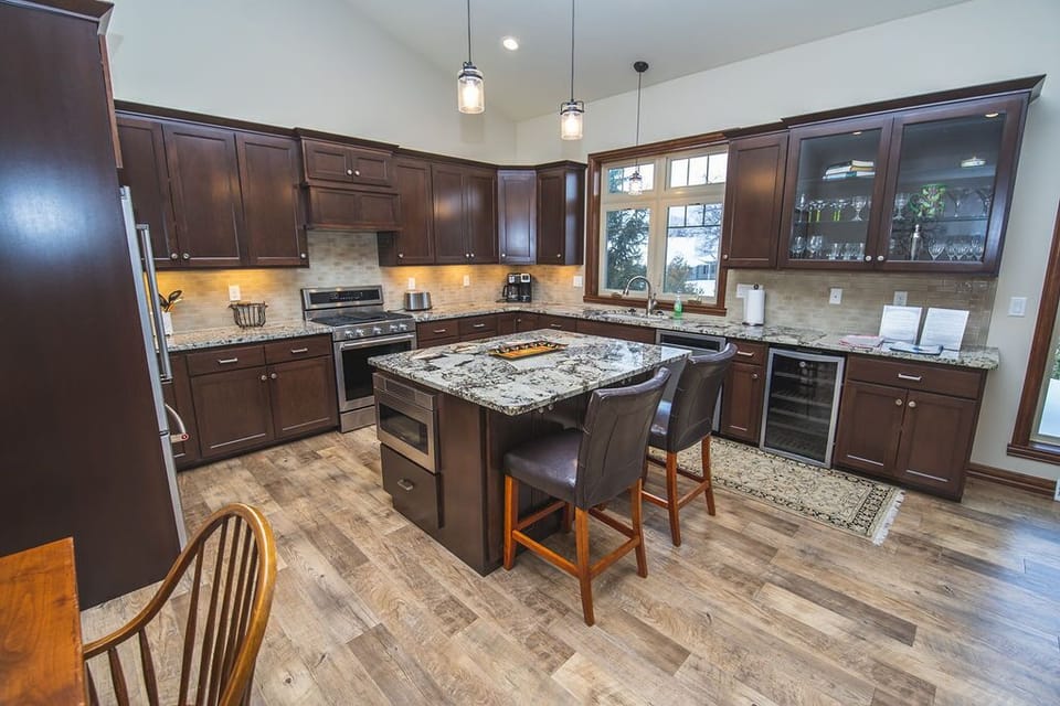 Kitchen with island and new stainless steel appliances.