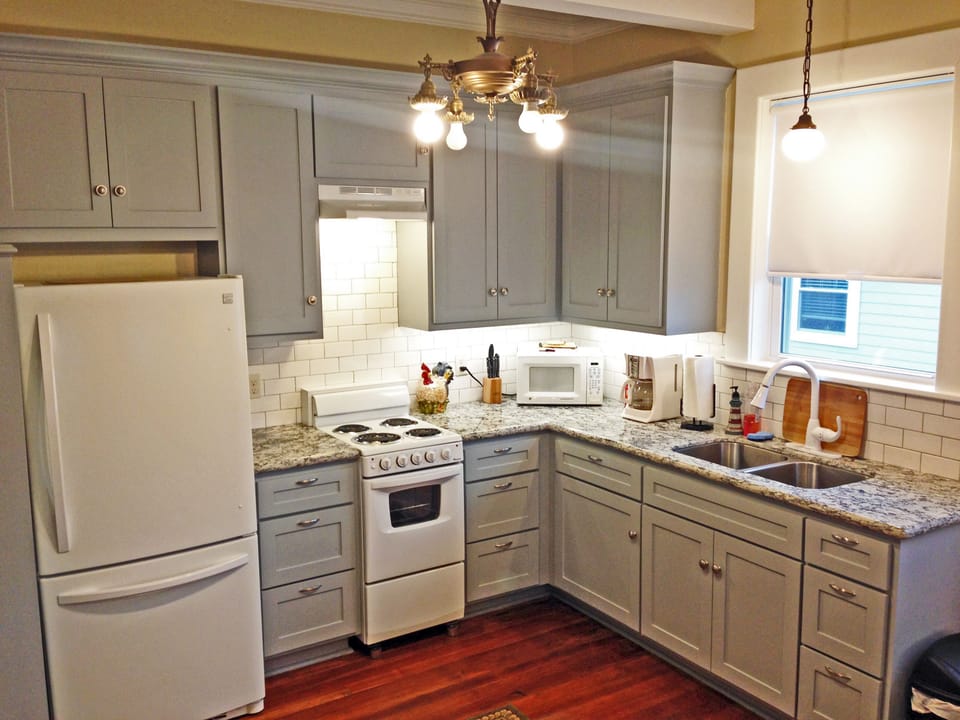 Kitchen has full size refrigerator, microwave,  stove/oven & granite countertop