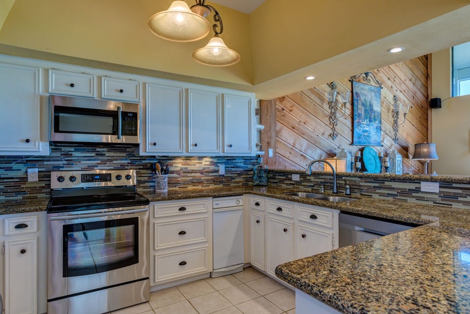 Spacious kitchen with new stainless steel appliances - fully stocked with basics
