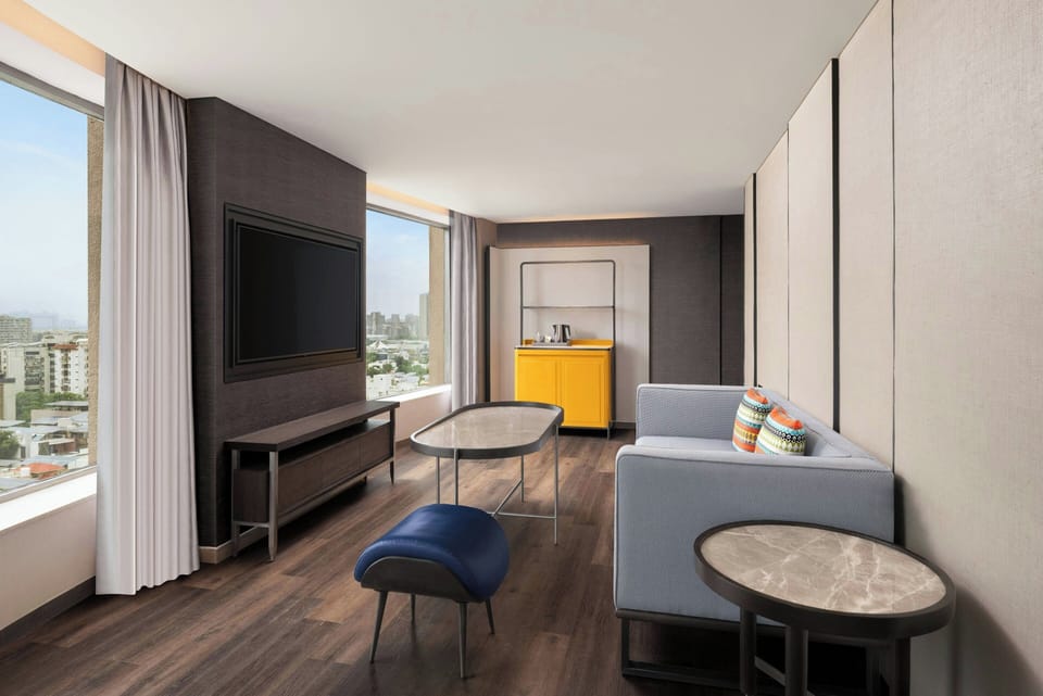 Signature Suite, 1 King Bed, City View | Living room | 55-inch flat-screen TV with satellite channels, TV, iPod dock