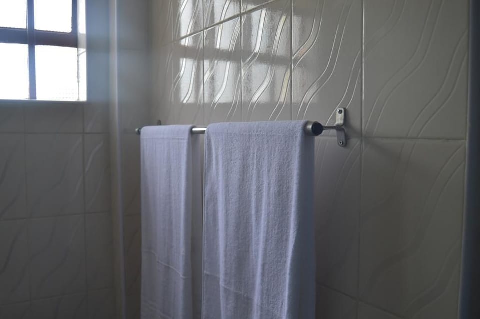 Shower, rainfall showerhead, slippers, towels