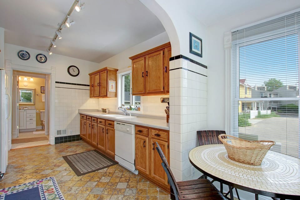 Kitchen with dishwasher, gas range, microwave, refrigerator with ice maker.