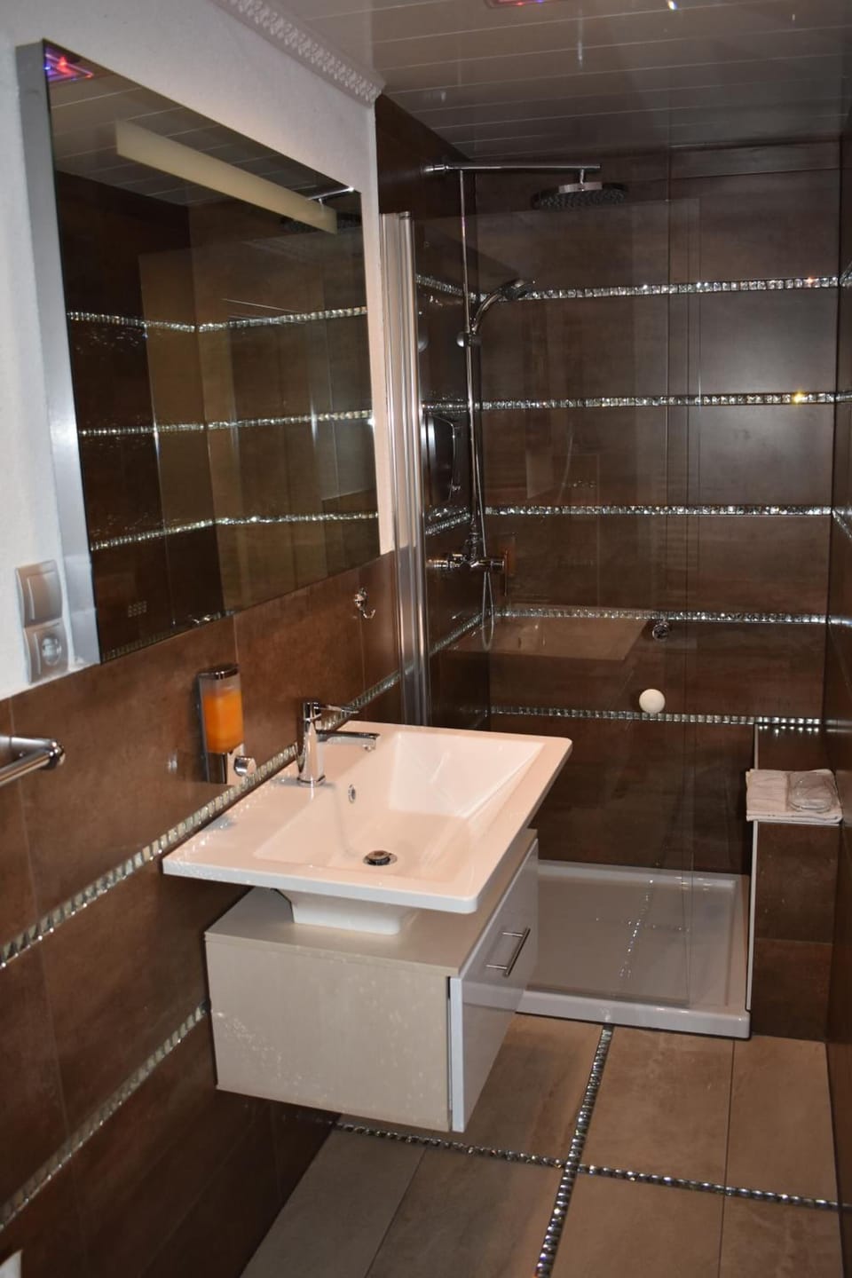 Shower, hair dryer, slippers, towels