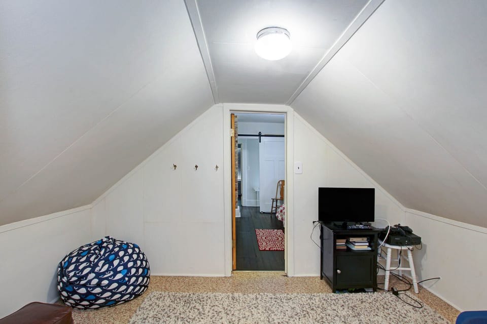 2nd floor childrens sitting room with bean bags, TV and video games.