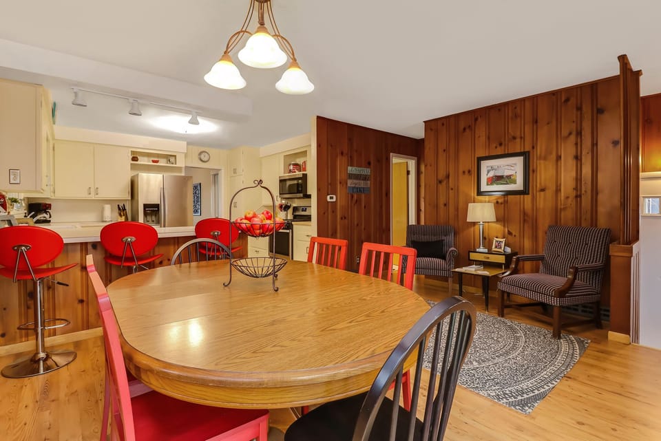 Two upholstered chairs are located opposite the kitchen table.