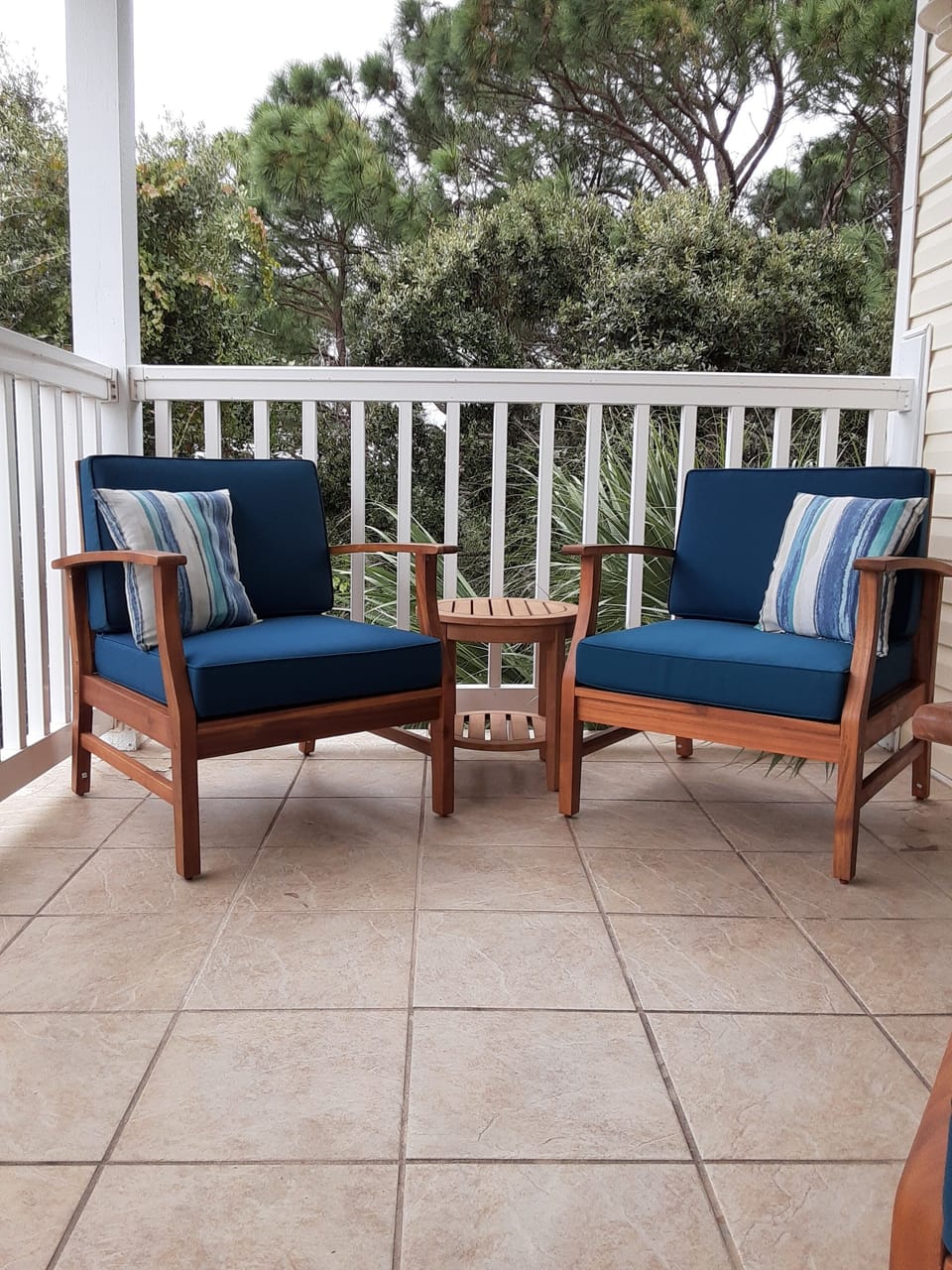 Large outdoor balcony with harsh views and seating  for four.