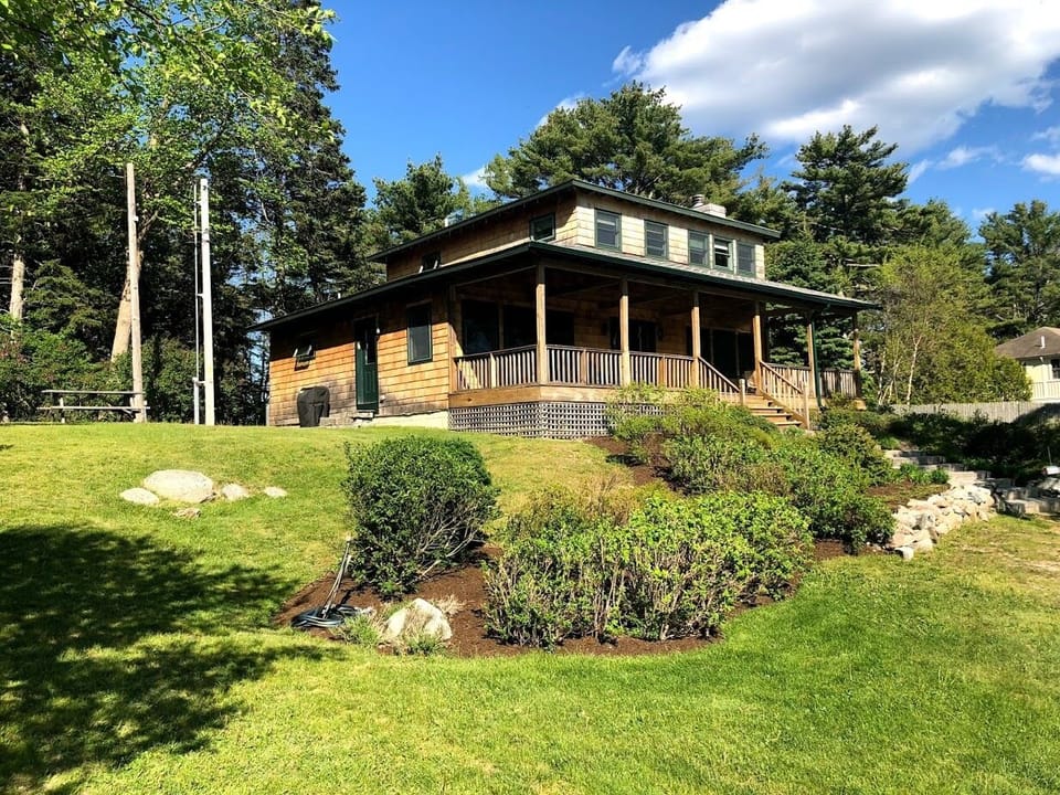 View of cottage and lawn
