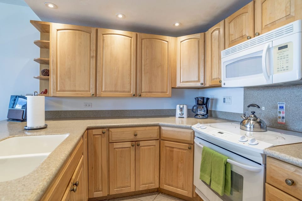 Fully equipped kitchen with custom cabinets, lighting and updated appliances