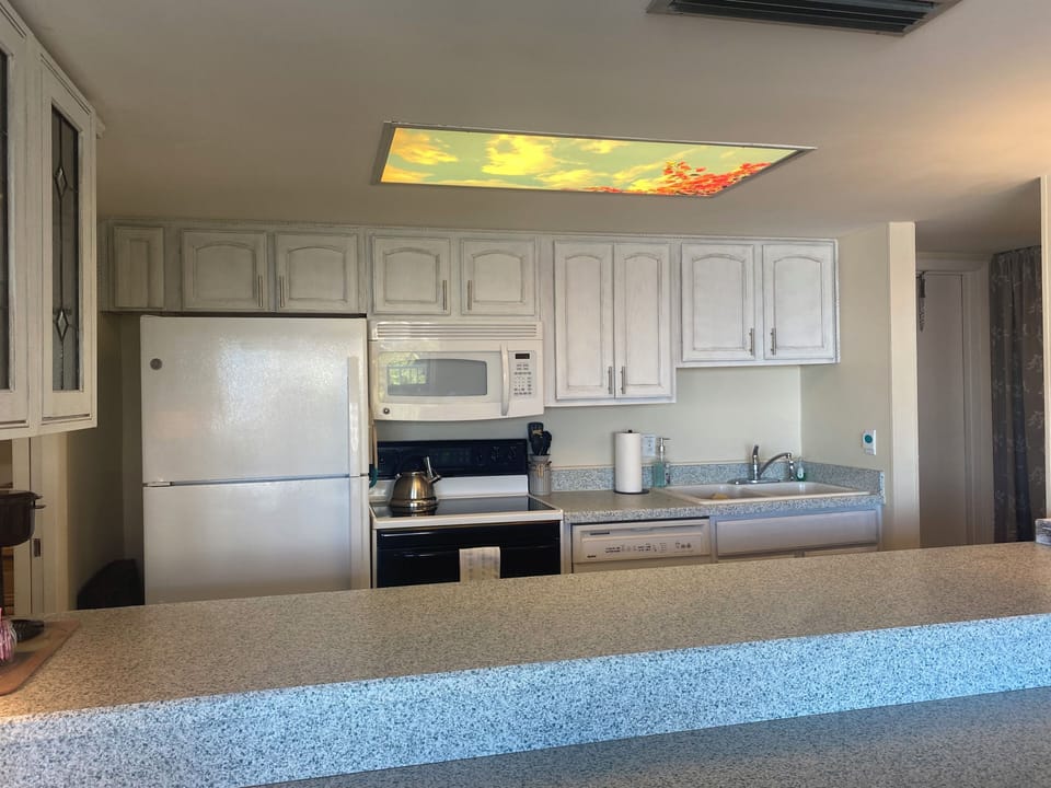 Full kitchen with access on left into a large pantry