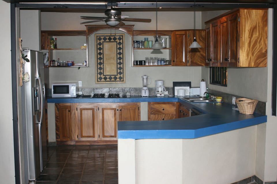 Kitchen fully loaded with Appliances, Plates, and Cutlery