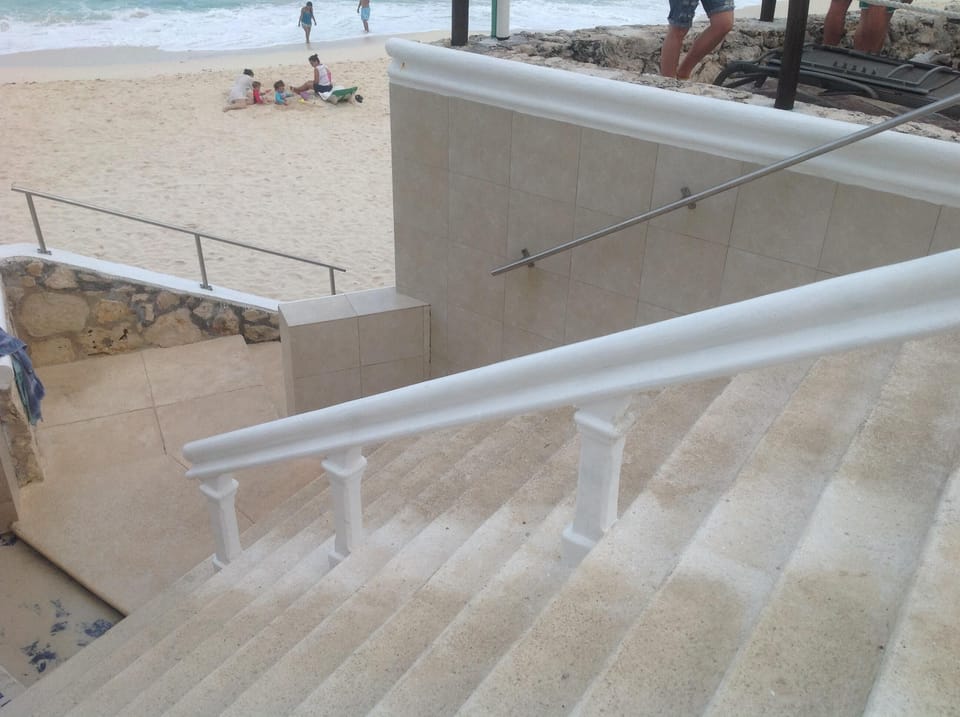Steps to the beach, showers on landing to rinse off sand