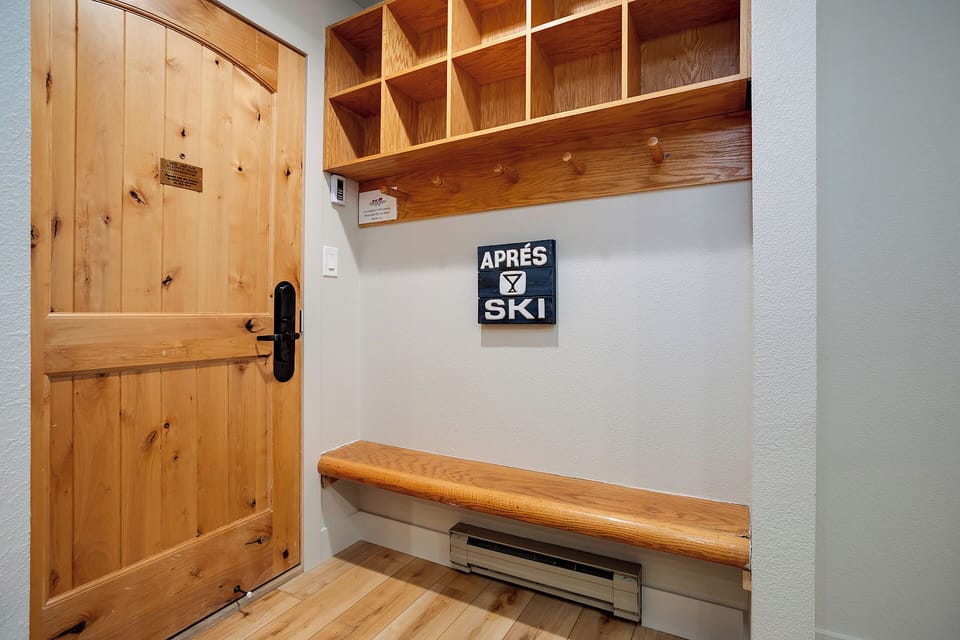Store your gear in warm wooden cubbies and settle onto the built-in bench after your mountain adventures.