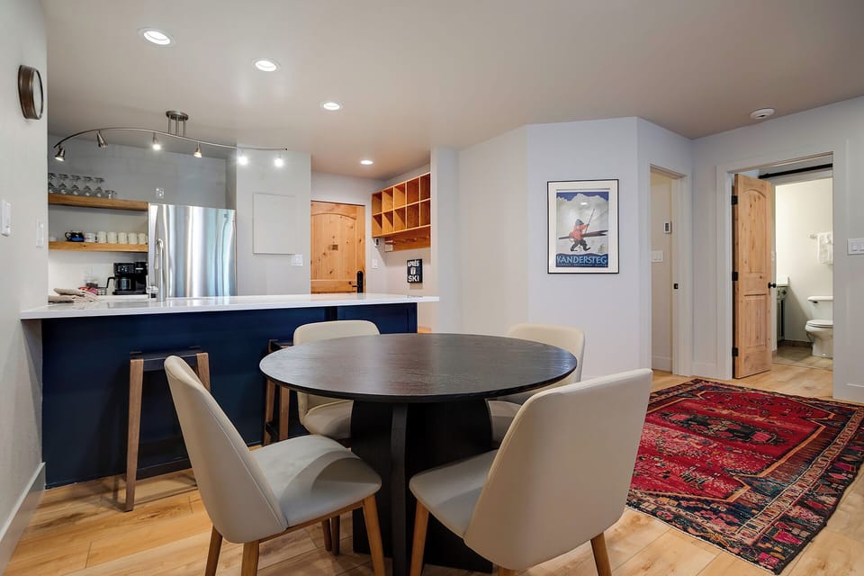 Your open-concept kitchen and dining space features modern appliances and a cozy round table, perfect for morning coffee or intimate dinners.