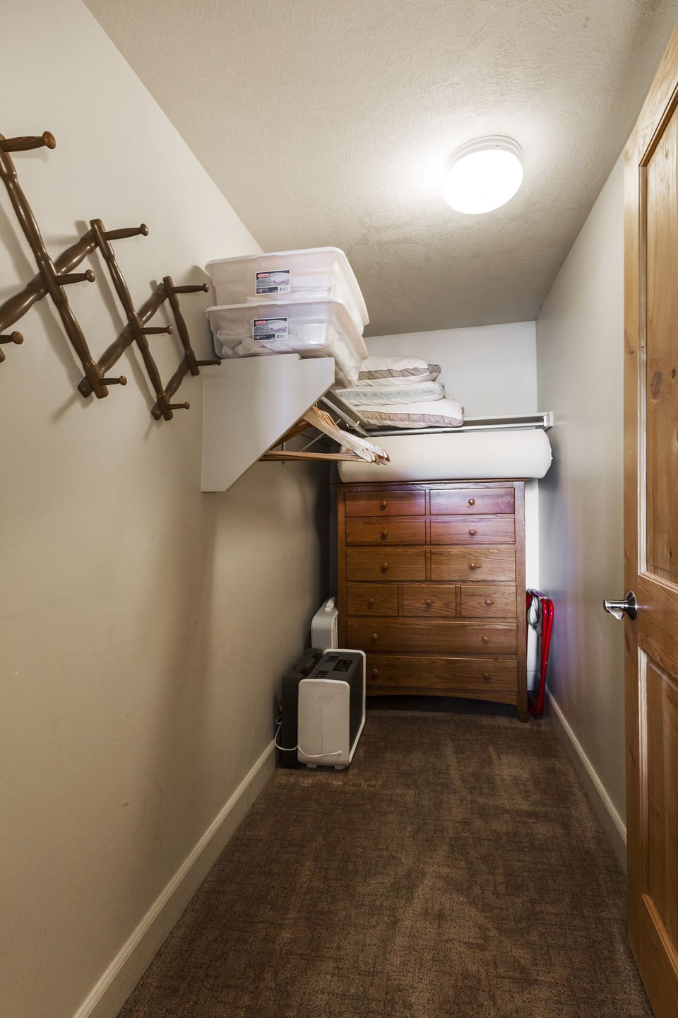 Master bedroom closet, wooden hangers and plenty of drawer space.