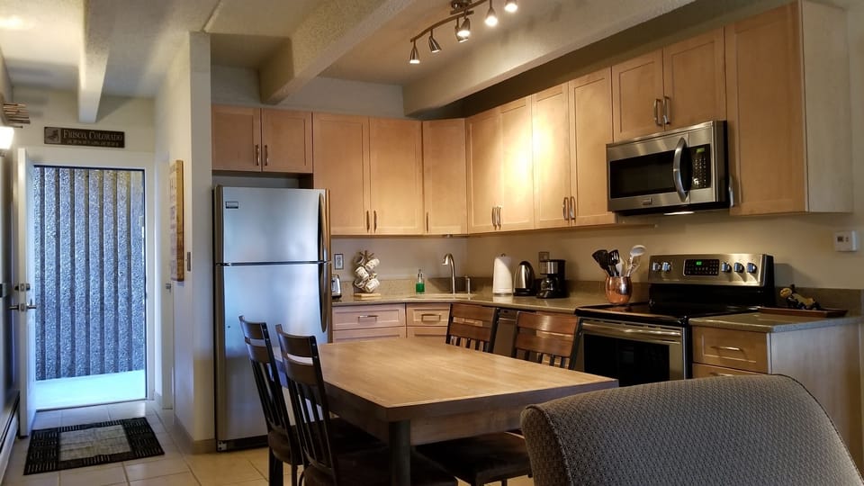 Kitchen area with view of private entrance to condo