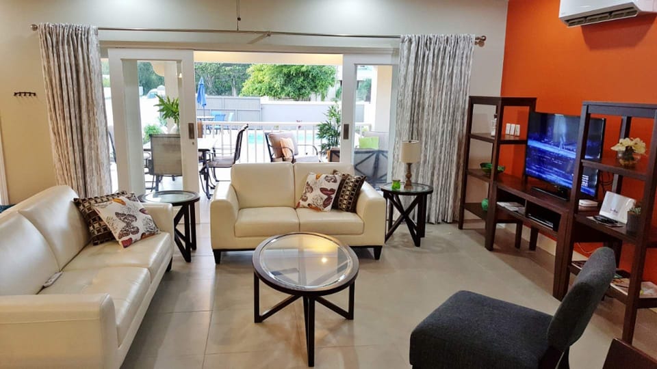 View of the Porch & pool beyond from the kitchen and dining areas
